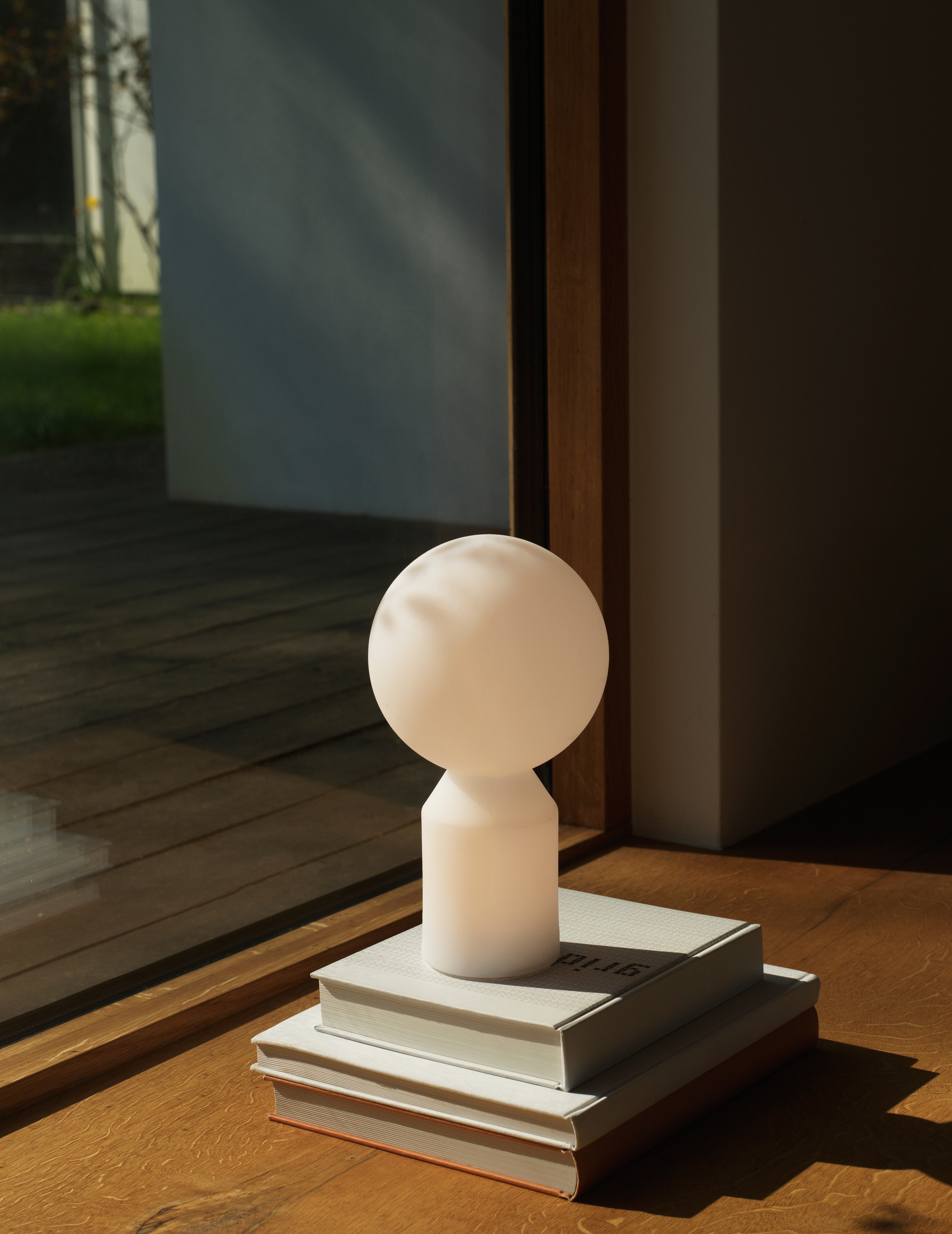 Yo LED portable lille bordlampe tændt i lyset mod vindue