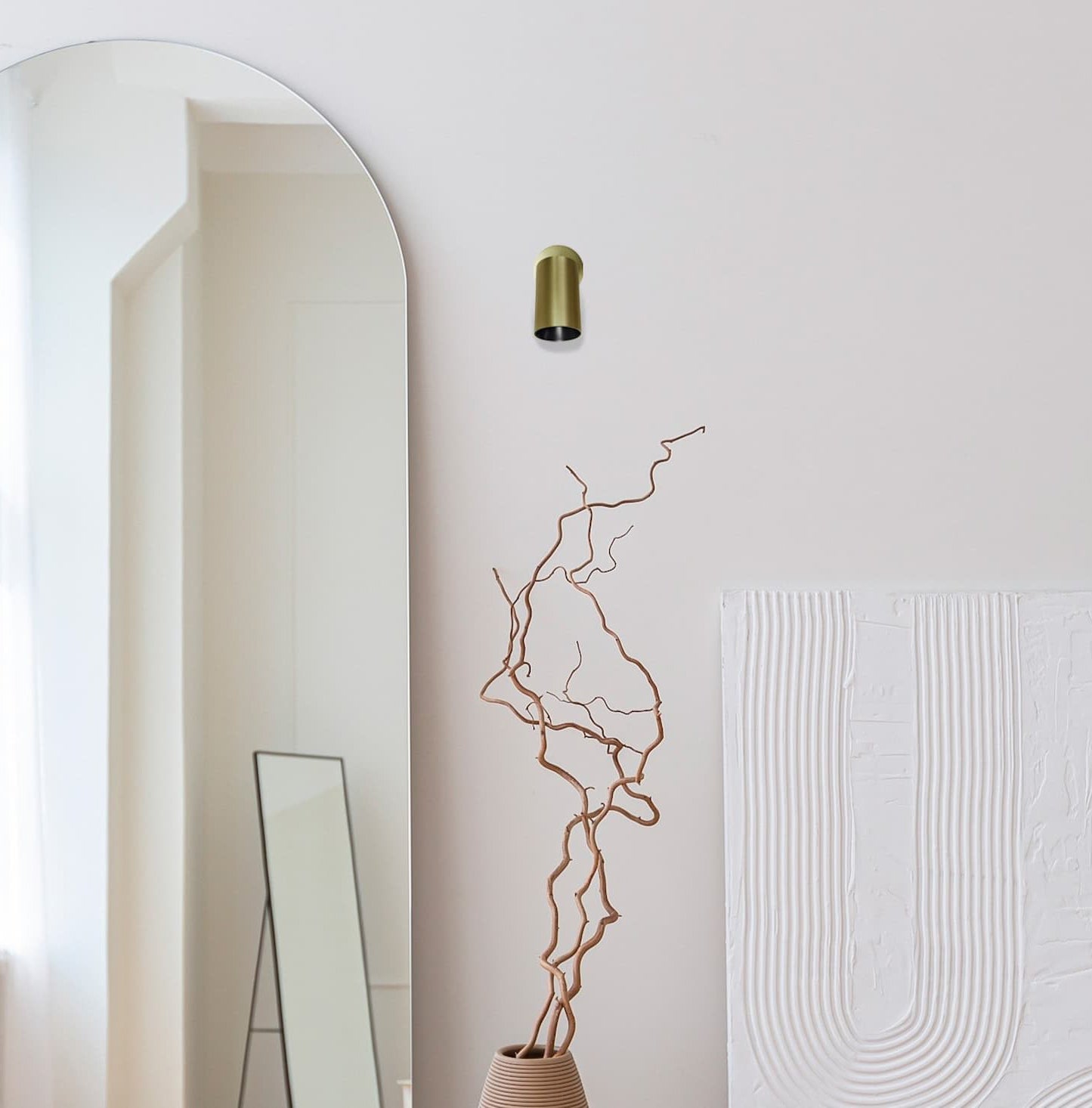 Minimalistisk indretning med en SpotOn Circle1 i messing på væggen fra Antidarks populære SpotOn-serie