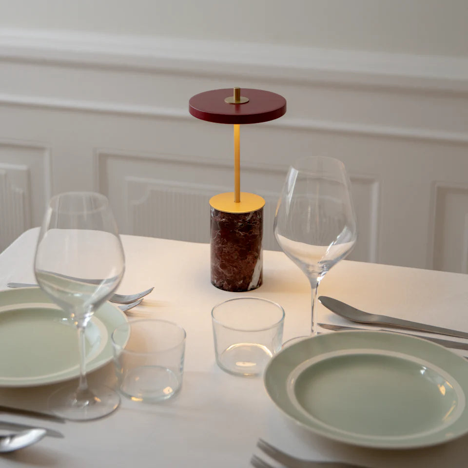 Umage's Asteria Move Mini Red Marble bordlampe på et spisebord