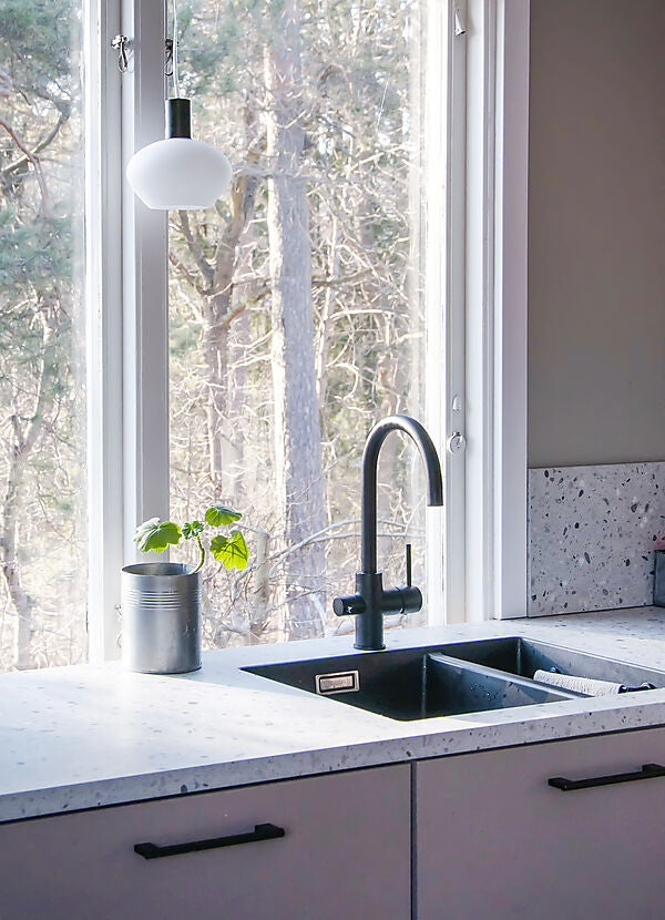 Den unikke designet Bell Pendel i Sort/Opal Hvid placeret i vindueskammen i køkkenet