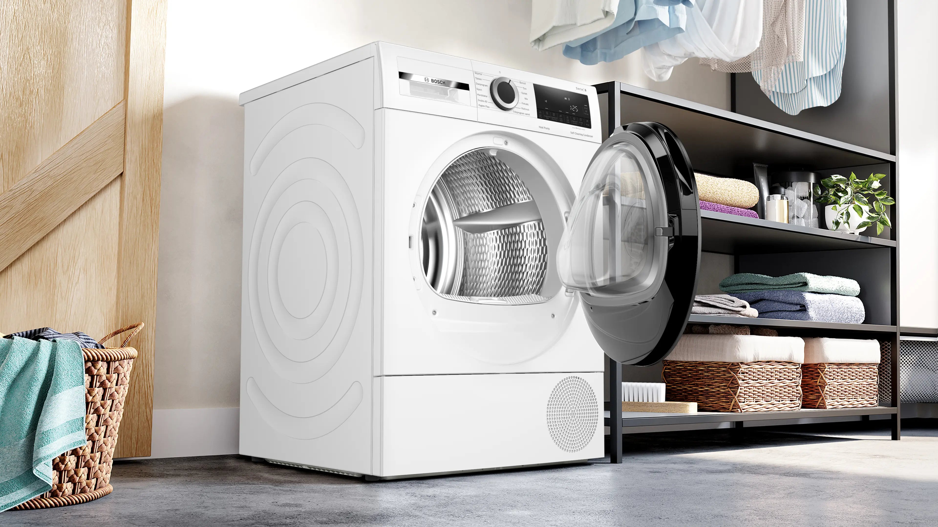 Den unikke designet Bosch WQG2450BSN tørretumbler med varmepumpe 9 kg placeret i vaskerummet