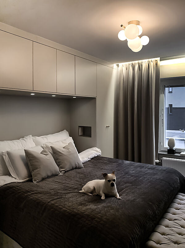 Den elegante designet Molekyl Loftslampe i Messing/Hvid hængt op på værelset for dens varme belysning