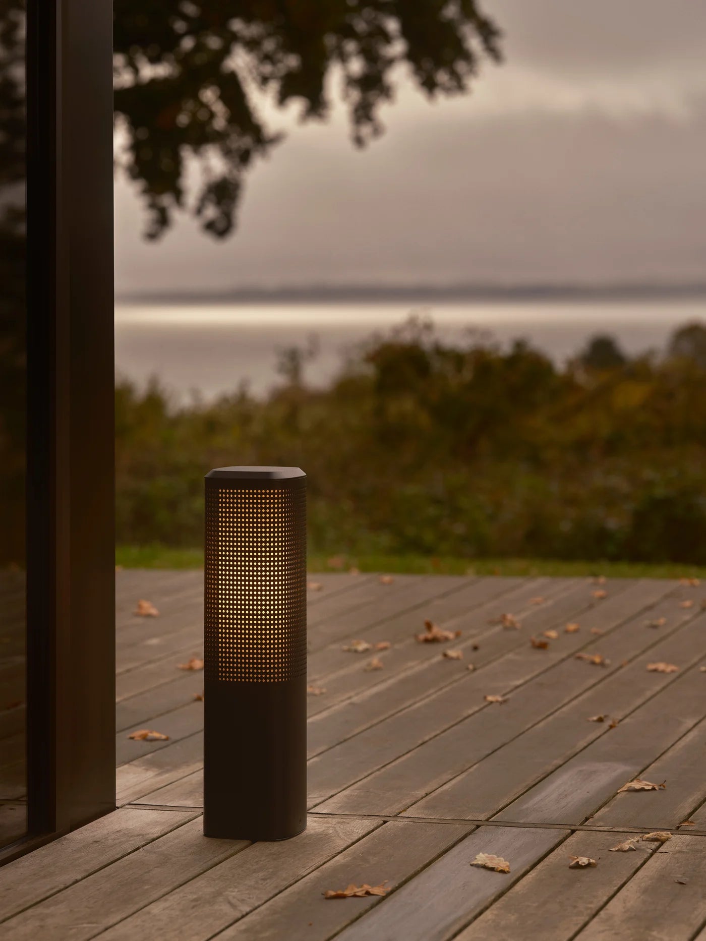 Den elegante Sidara 45 Havelampe Seaside i Sort placeret udenfor på terrassen for dens varme belysning
