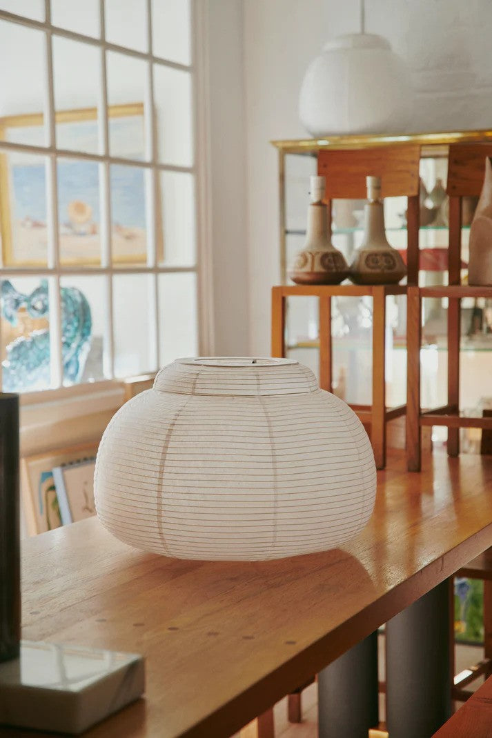 Den æstetiske Papier Single Ø52 Pendel i Hvid placeret på et bord