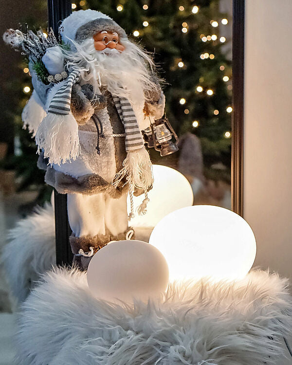 Den elegante designet Globus Ø18 Bordlampe i Hvid placeret foran en julemand for dens hyggelige belysning