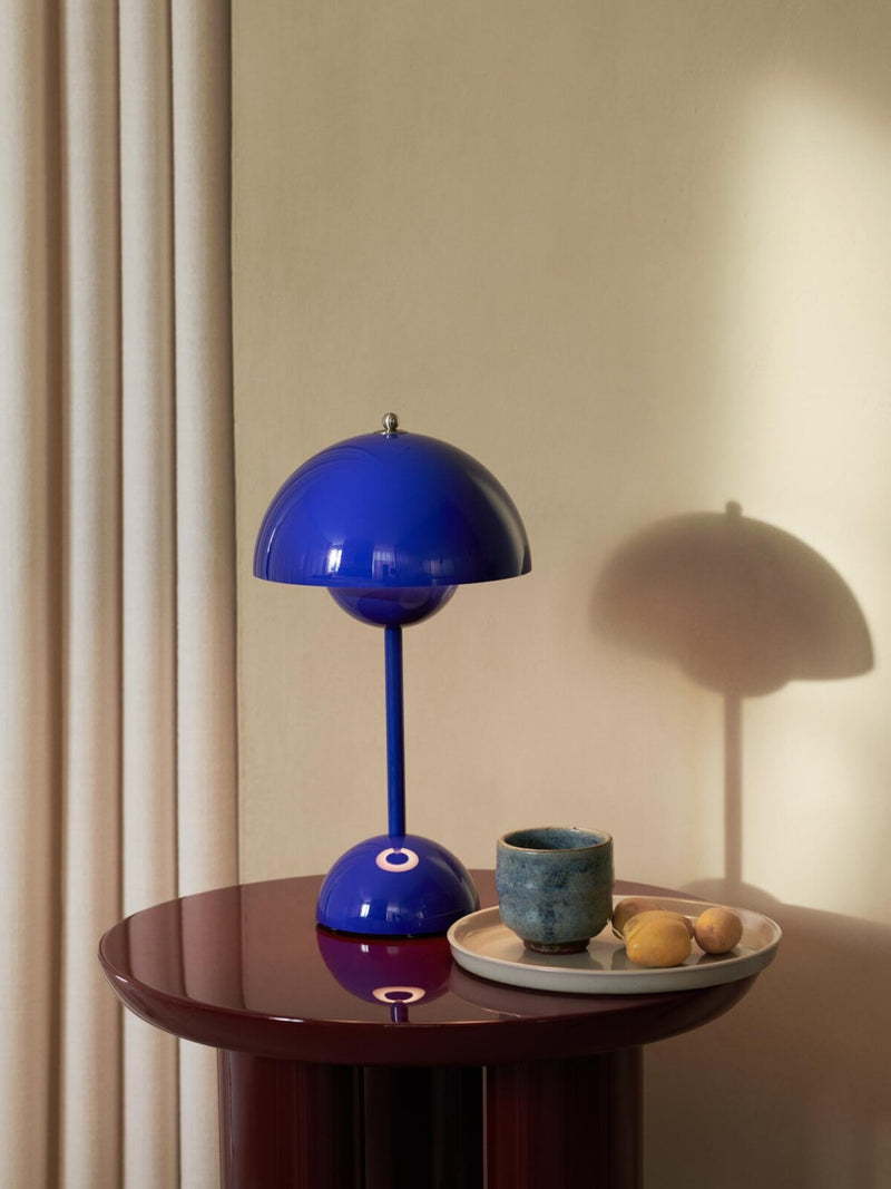 Blå Flowerpot bordlampe på et lille træbord sammen med en kop kaffe